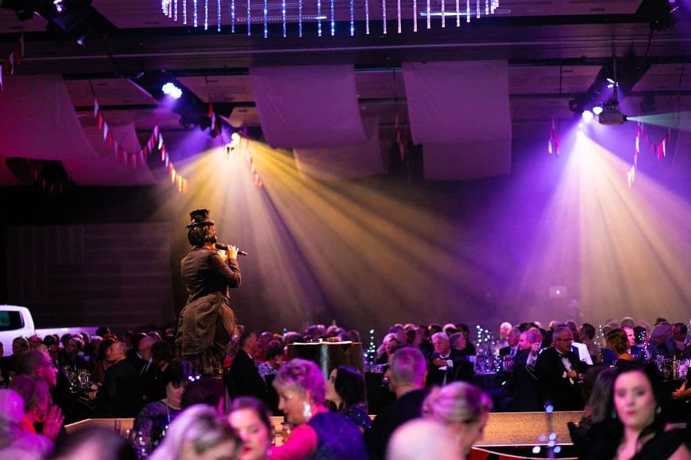 Centre stage with the MC informing guests of the evenings programme, Heaphy room, Claudelands Event Centre - LJ Hooker Cancer Ball