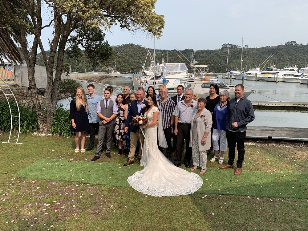 Salt Restaurant and Bar​ - Wedding guests and bride and groom posing on lawn