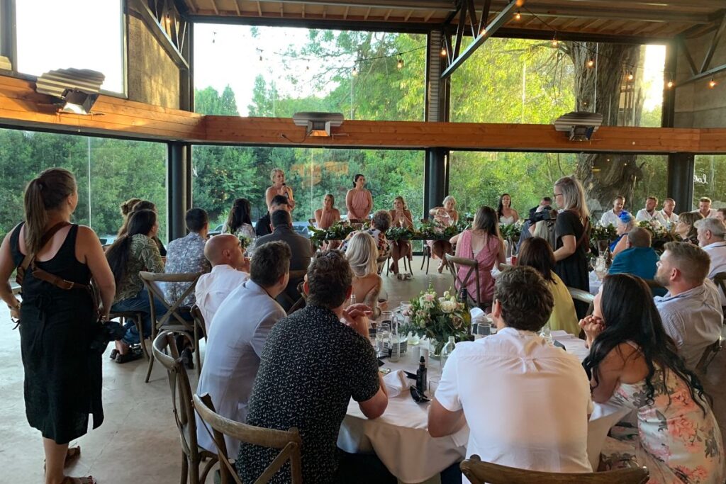 Speeches at a wedding recpeiton with guests seated in the Pirongia room at The Narrows Landing
