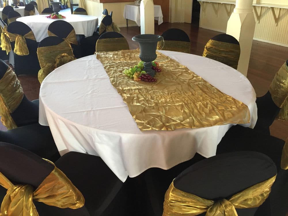Hawkes Bay Racing Centre - Round Guests Table Black Chair Coverings with Gold Sash and Table with White Cloth