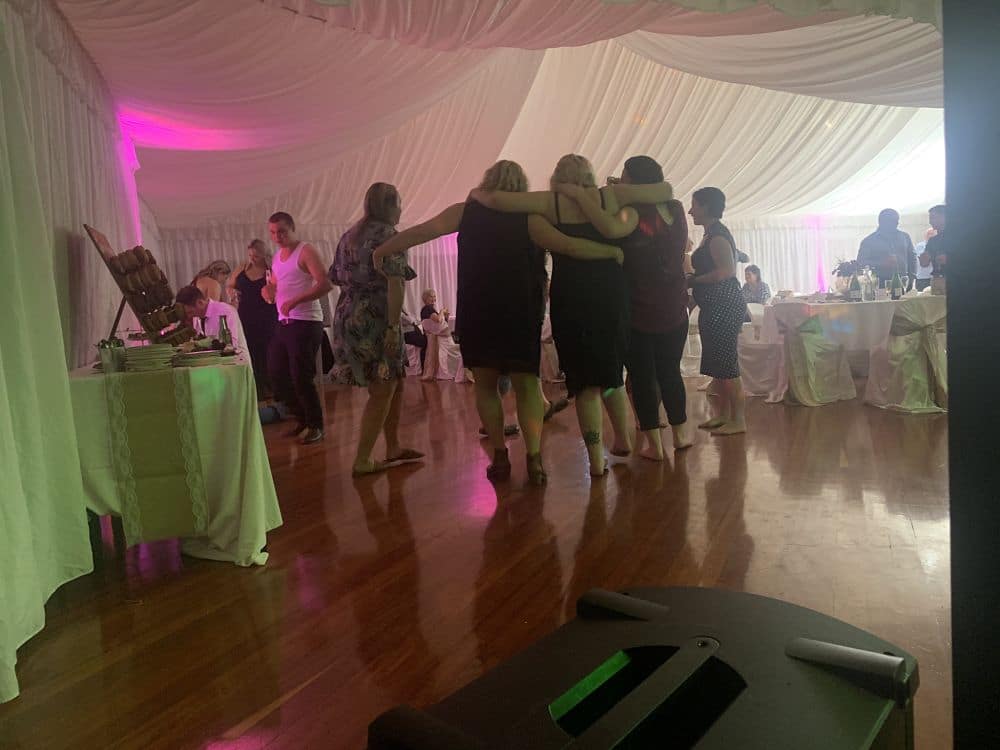 Wedding Guests posing for photo on the dance floor at reception held in Newbury Hall Palmerston North
