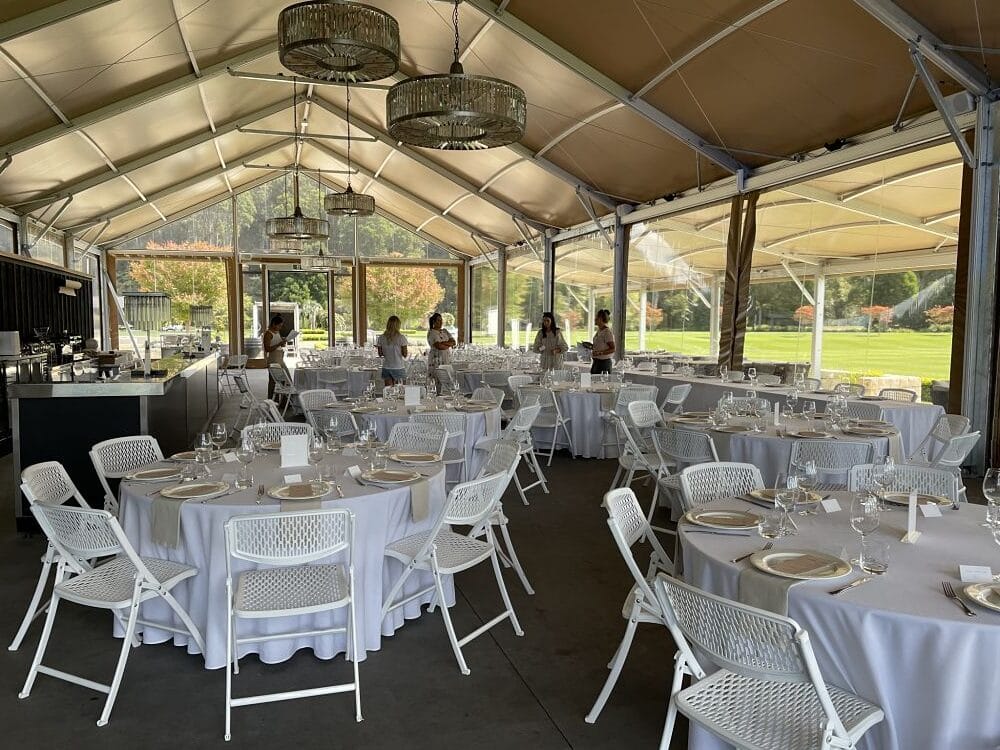 Takapoto Estate - Round tables in white linen set in marquee for wedding reception