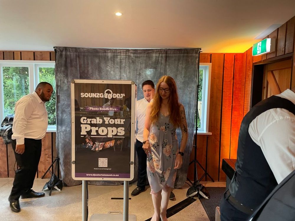 Wedding guests using photo booth inside The Black Barn - Tarawera Lake - Rotorua